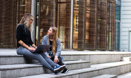 women sitting on steps